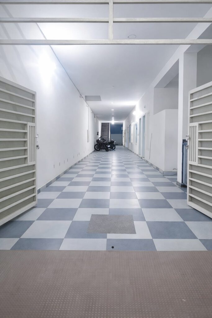 "Clean and spacious corridor at Neeldhari House boys PG Rajpura"